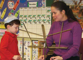 Ms. Lessure teaching a young student.